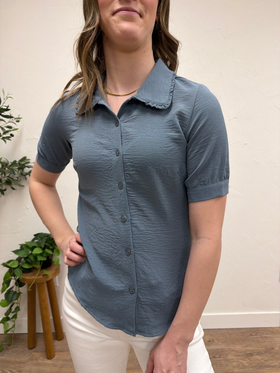 Close up of ruffle collar detail on blouse neckline — Three:Twelve Boutique