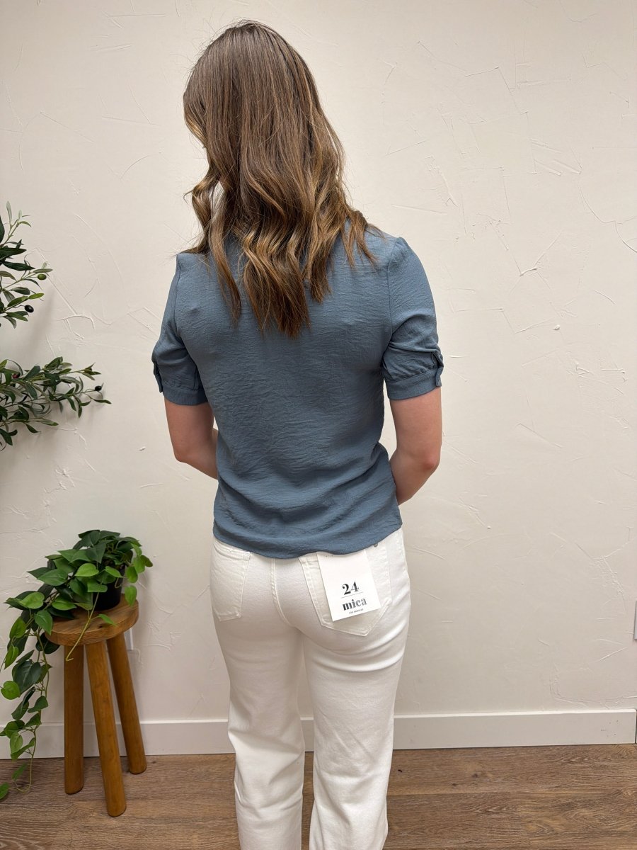 Back view of ruffled collared blouse on model showing relaxed fit — Three:Twelve Boutique