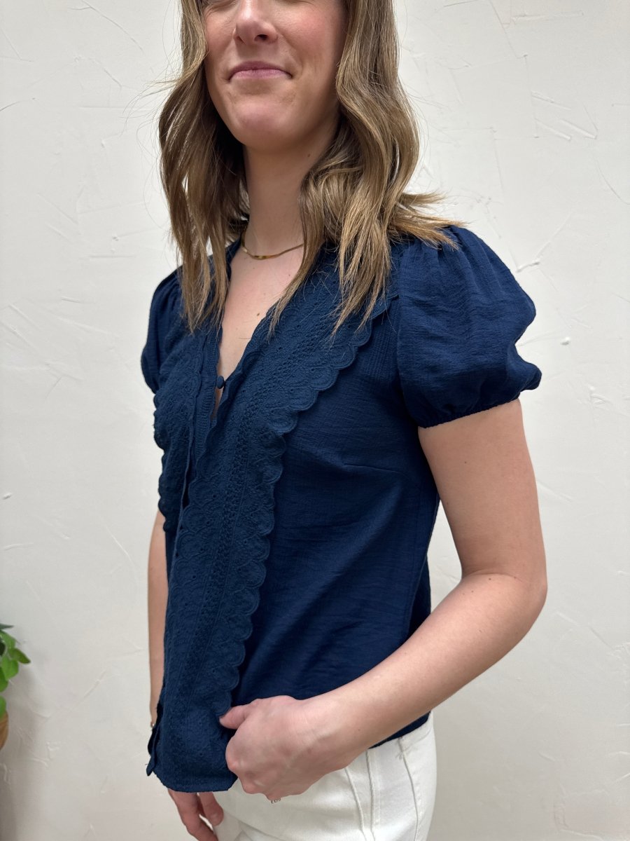 Side angle view of V-neck lace top highlighting scallop edge design — Three:Twelve Boutique