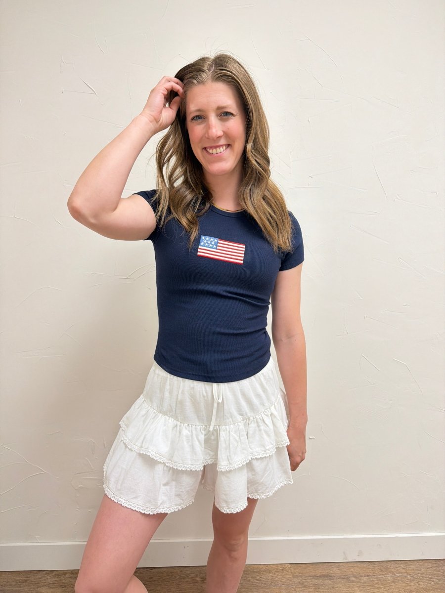 Lifestyle image of model wearing Short Sleeve American Flag Tee with casual denim — Three Boutique