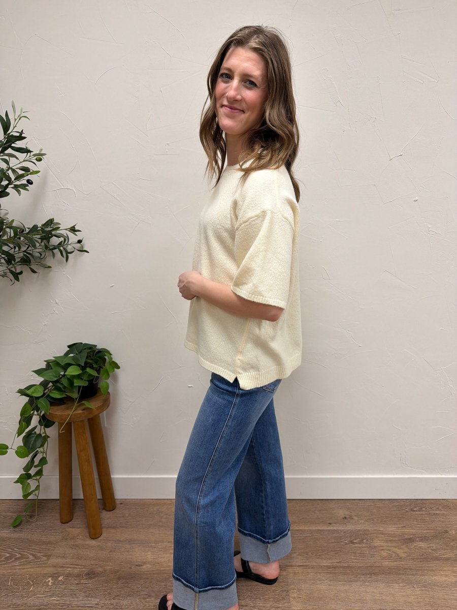 Side angle of short sleeve knit sweater showing sleeve length and drape — Three:Twelve Boutique