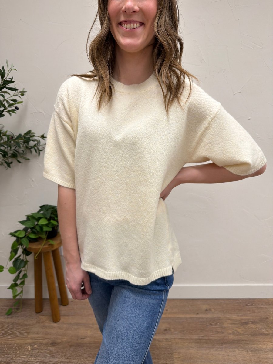 Front view of model wearing short sleeve knit sweater in neutral color — Three:Twelve Boutique