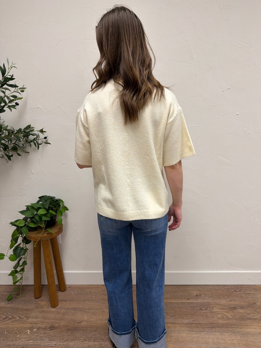 Back view of model showing short sleeve knit sweater silhouette — Three:Twelve Boutique