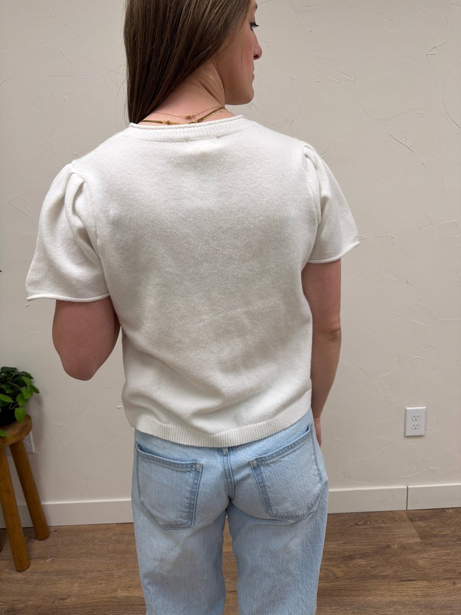 Back view of model wearing lightweight short sleeve knit cardigan — Three:Twelve Boutique
