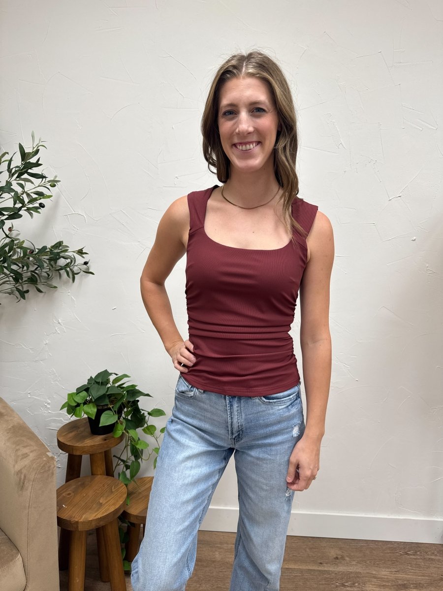 Front view of model wearing sleeveless ruched detail knit top in burgundy — Three:Twelve Boutique