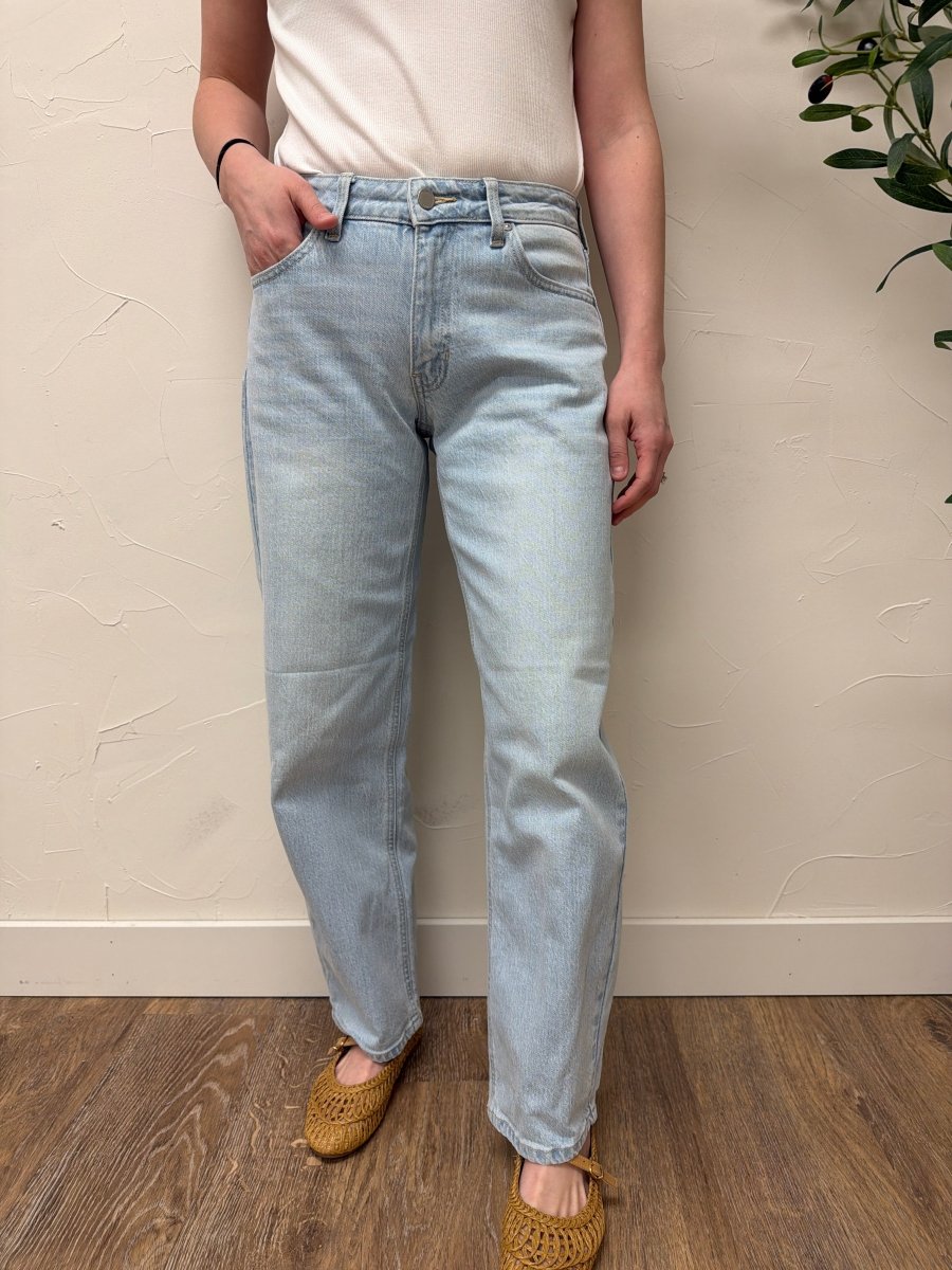 Lifestyle shot of model wearing denim styled with casual top — Three:Twelve Boutique