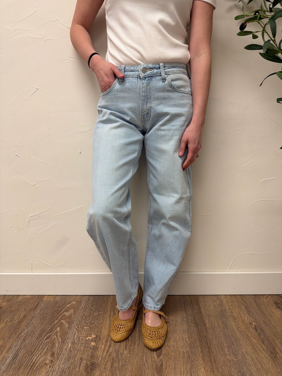 Lifestyle shot of model wearing denim styled with casual top — Three:Twelve Boutique