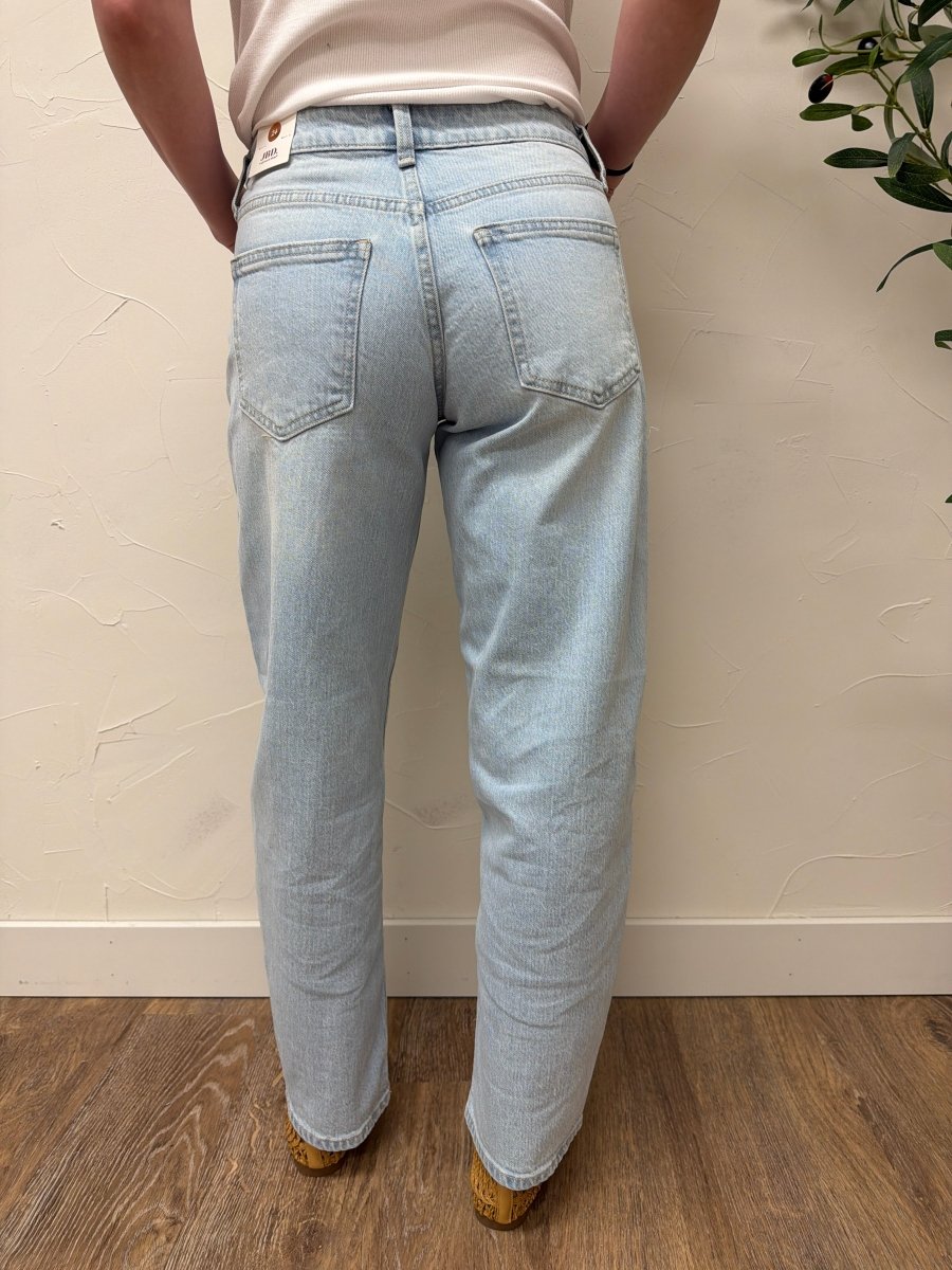 Back view of model wearing denim highlighting fit and pocket detail — Three:Twelve Boutique