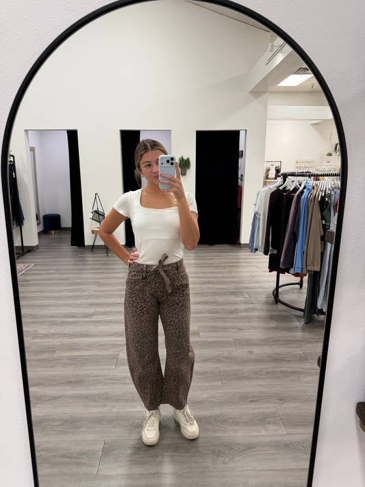 Lifestyle shot of model wearing slouchy crop barrel jeans with casual top and sneakers — Three:Twelve Boutique