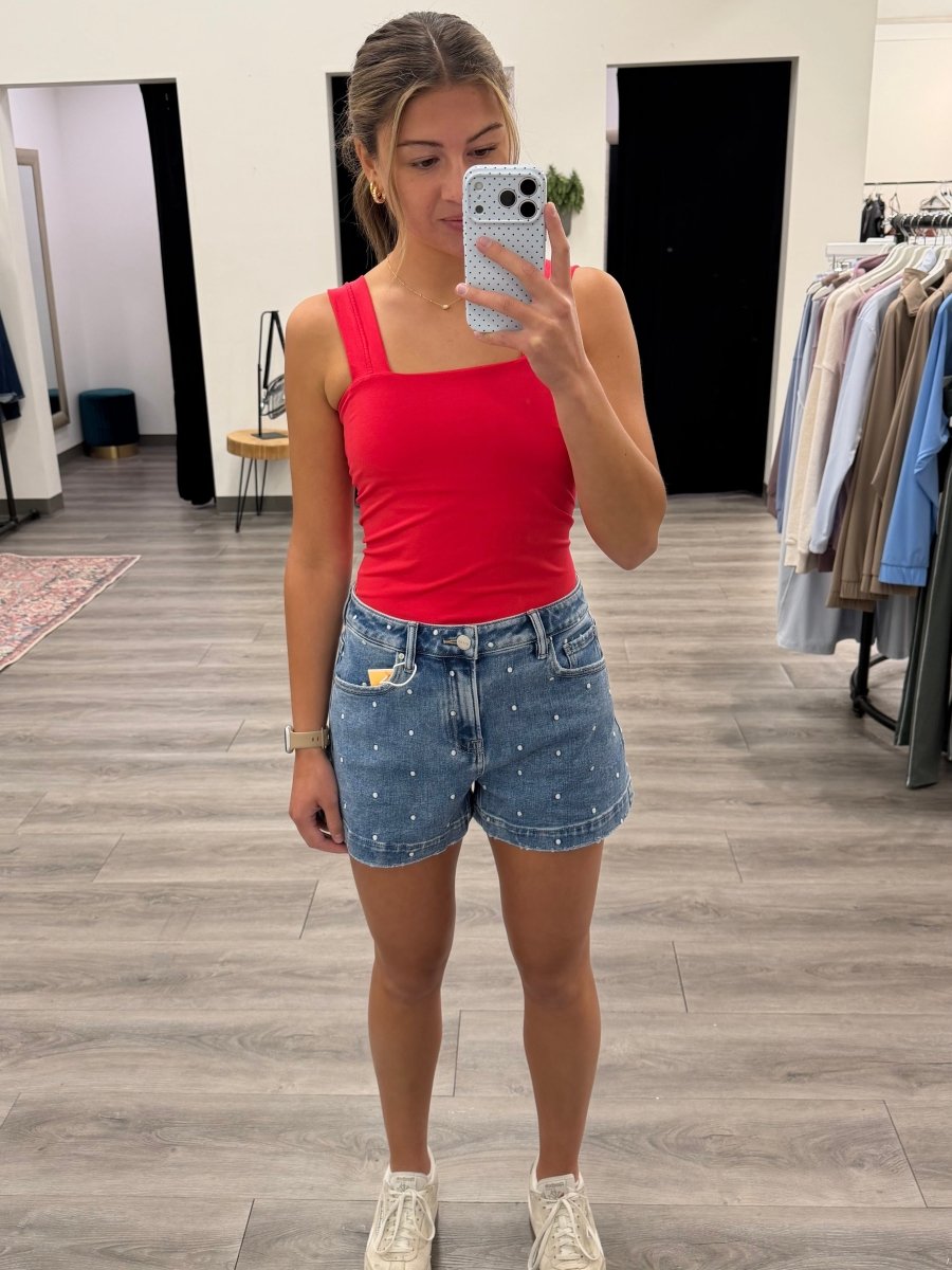 Lifestyle shot of model wearing embroidered shorts styled casually — Three:Twelve Boutique