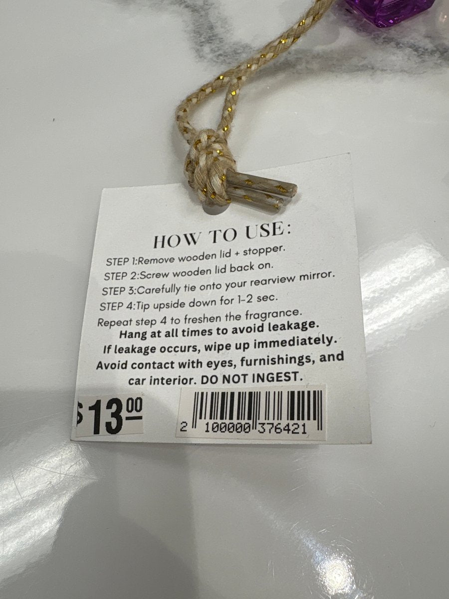 Detail of wooden cap and hanging string on car diffuser — Three:Twelve Boutique