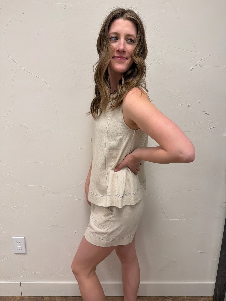 Side view of sleeveless top showing arm opening and drape — Three:Twelve Boutique