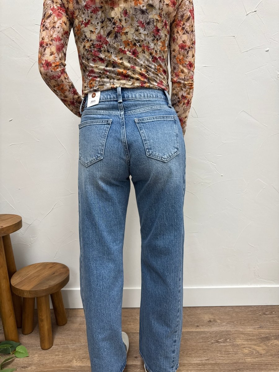 Back view of model wearing barrel twist jeans highlighting fit through hips and legs — Three:Twelve Boutique