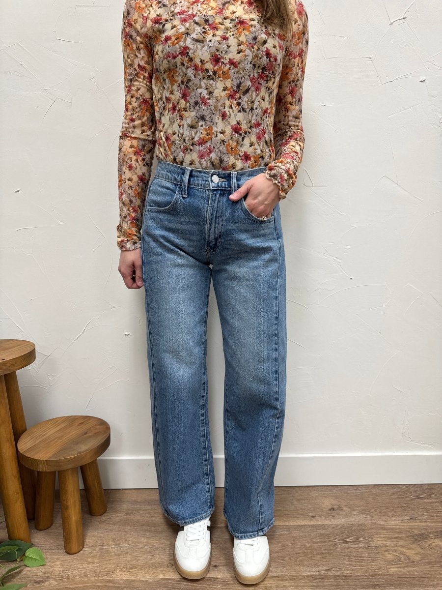 Lifestyle shot of model styling barrel twist jeans with casual top — Three:Twelve Boutique