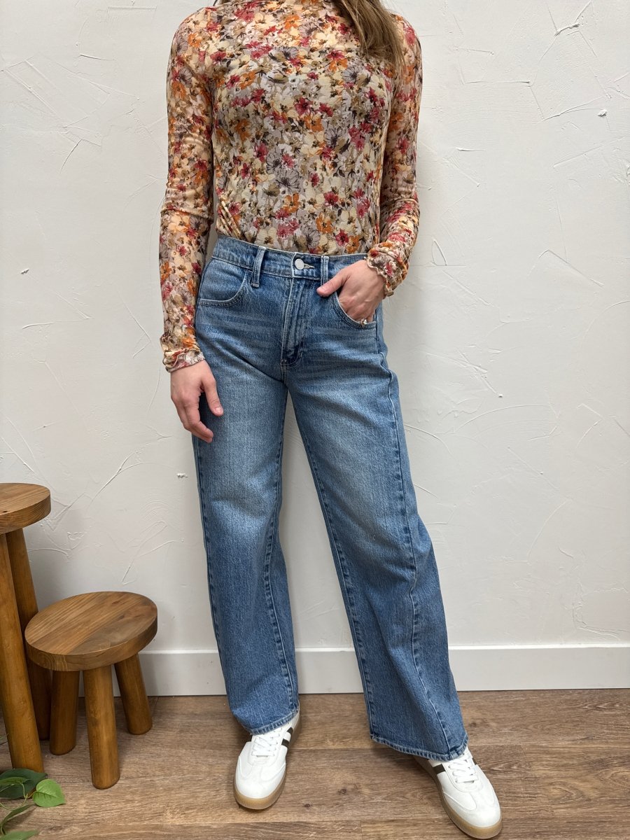 Lifestyle shot of model styling barrel twist jeans with casual top — Three:Twelve Boutique