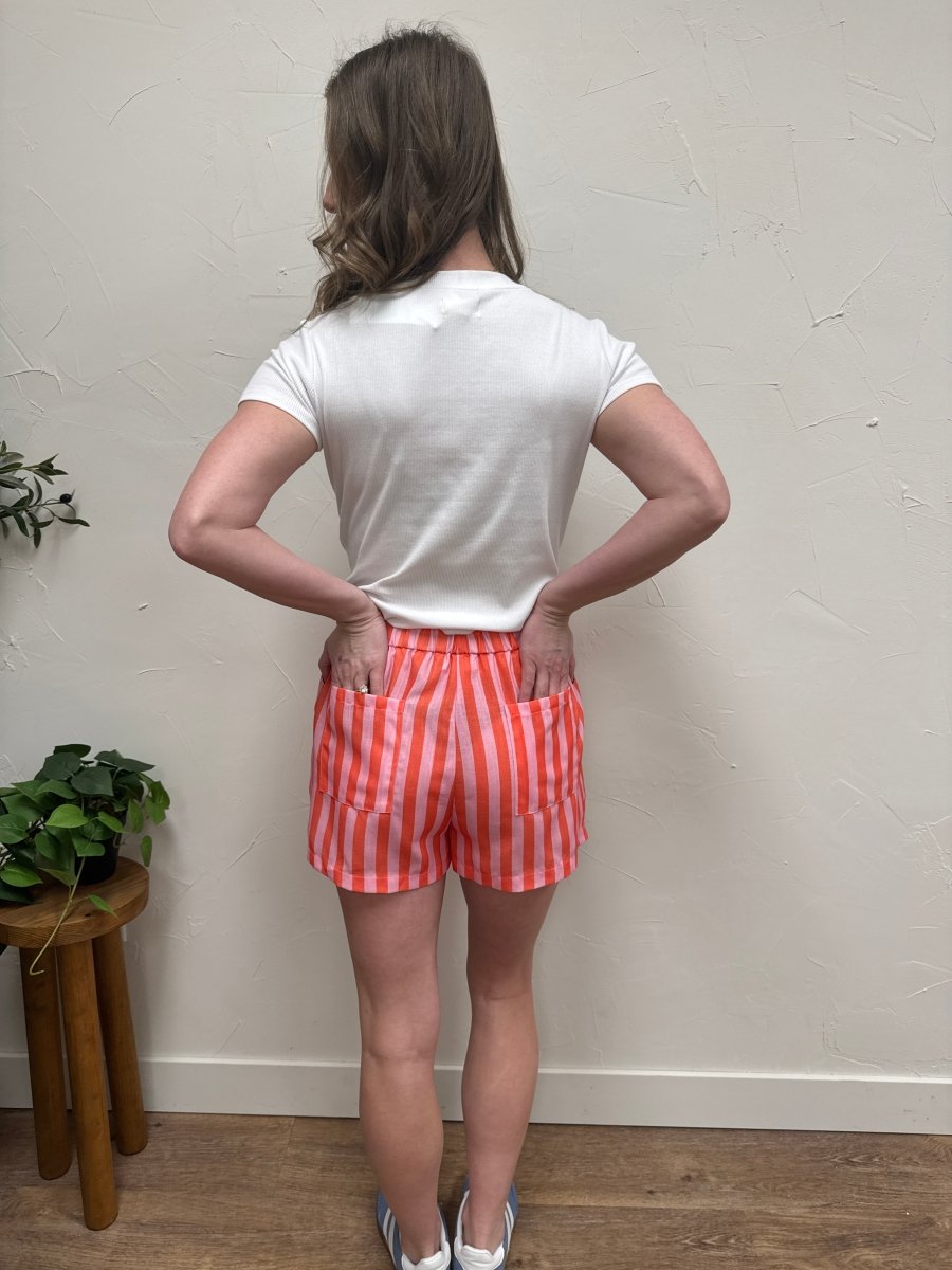 Back view of striped shorts on model displaying relaxed silhouette — Three:Twelve Boutique
