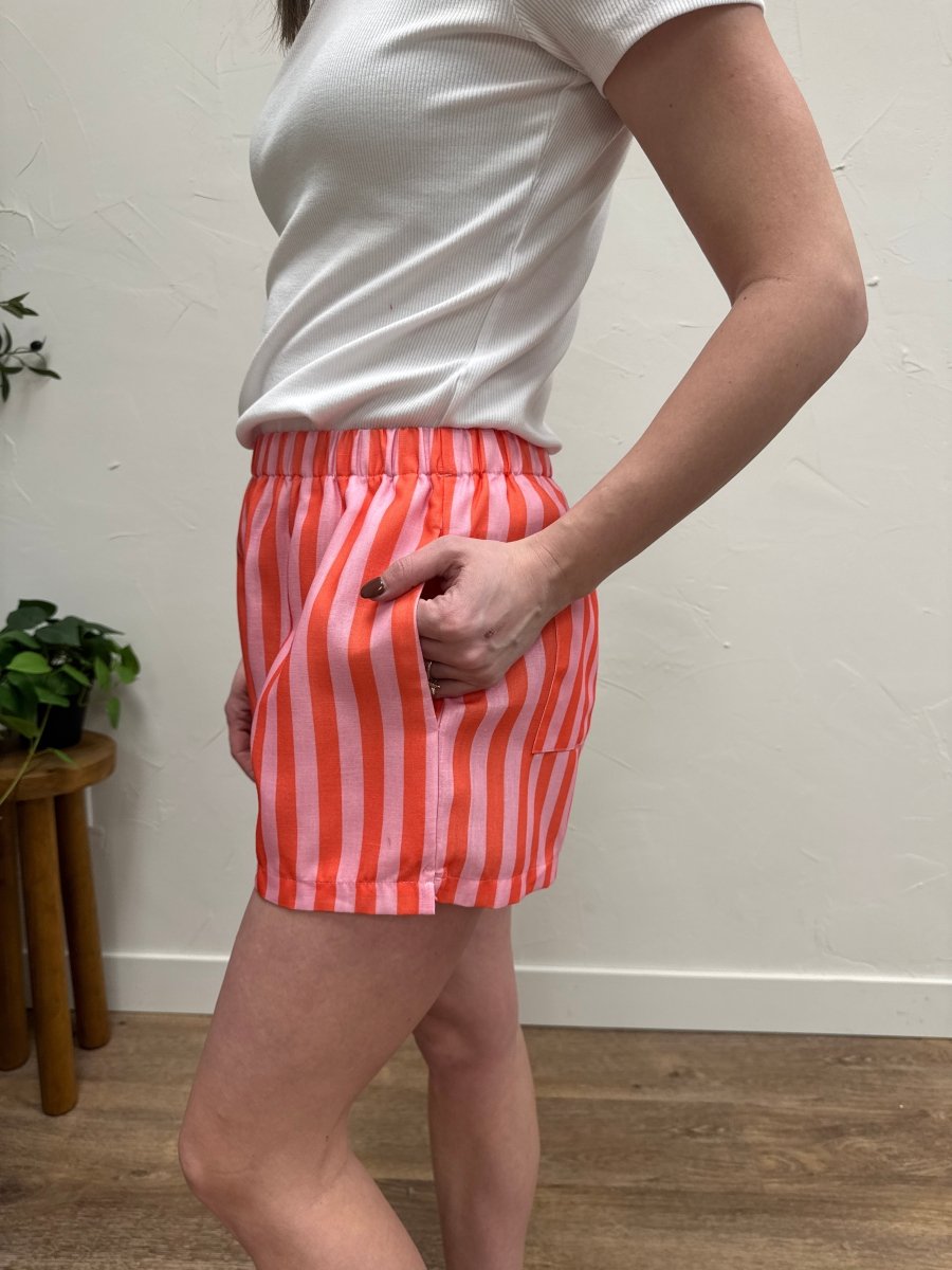 Side angle view of striped shorts highlighting length and fit — Three:Twelve Boutique