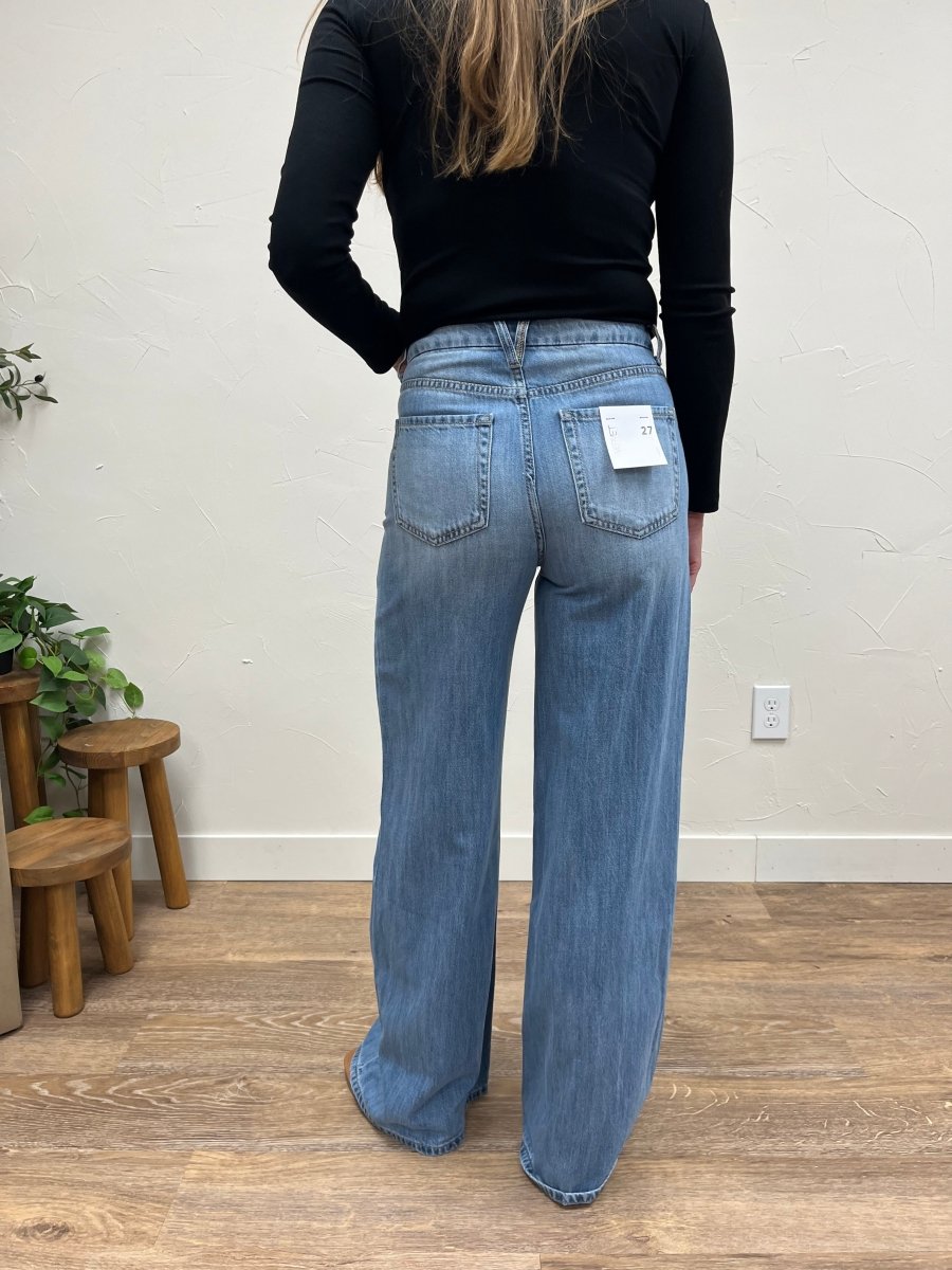 Back view of wide leg jeans on model highlighting high rise waist and relaxed shape — Three:Twelve Boutique