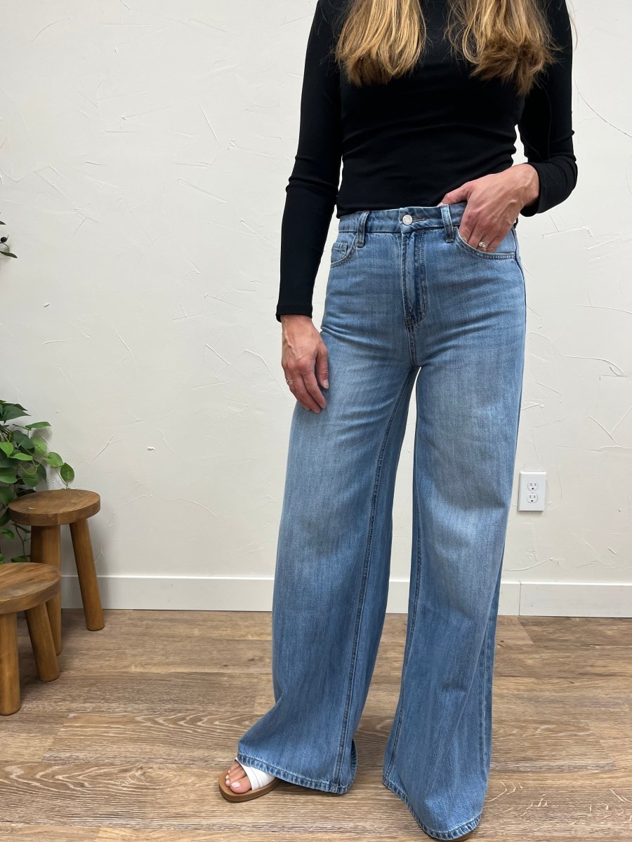 Close up of denim fabric and waistband detail on wide leg jeans — Three:Twelve Boutique