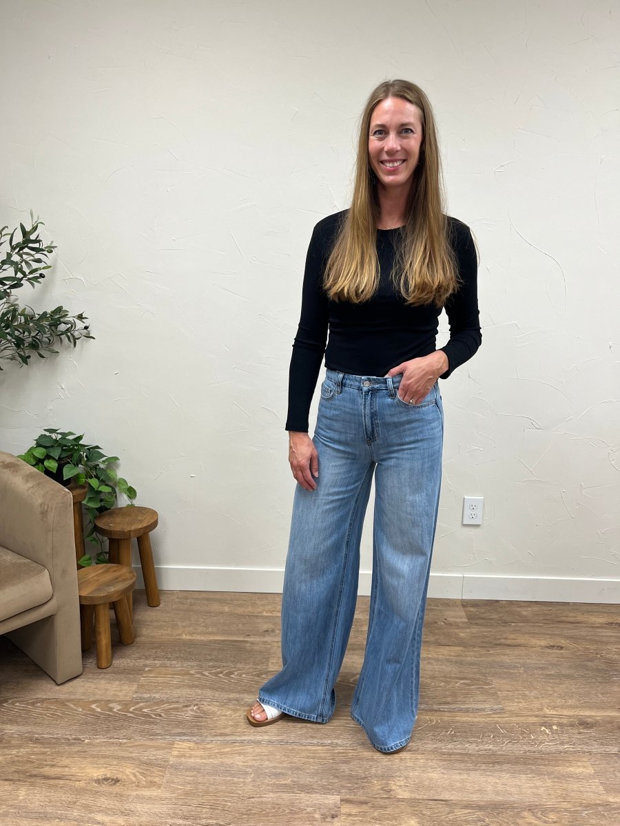 Front view of model wearing super high rise wide leg jeans showing full length fit — Three:Twelve Boutique