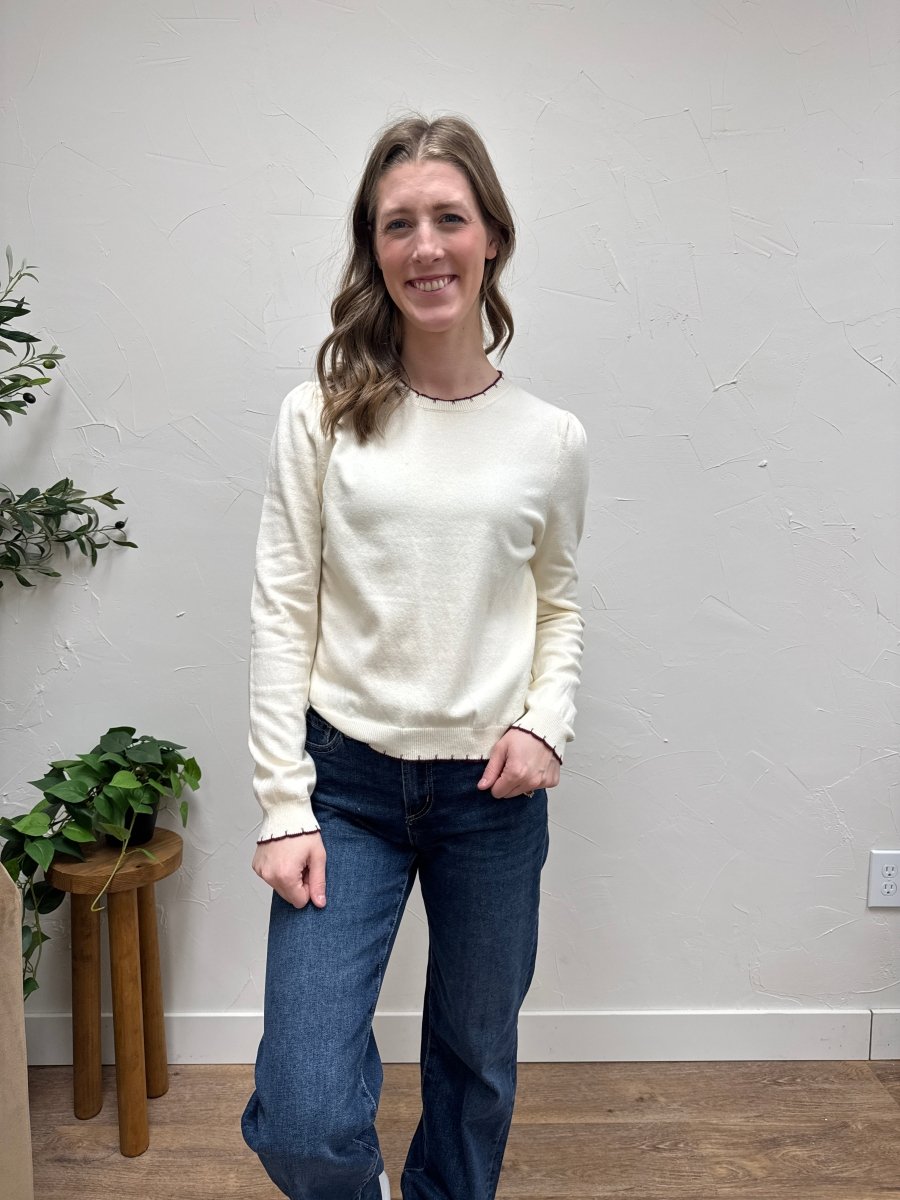 Lifestyle shot of model wearing sweater styled with casual denim outfit — Three:Twelve Boutique