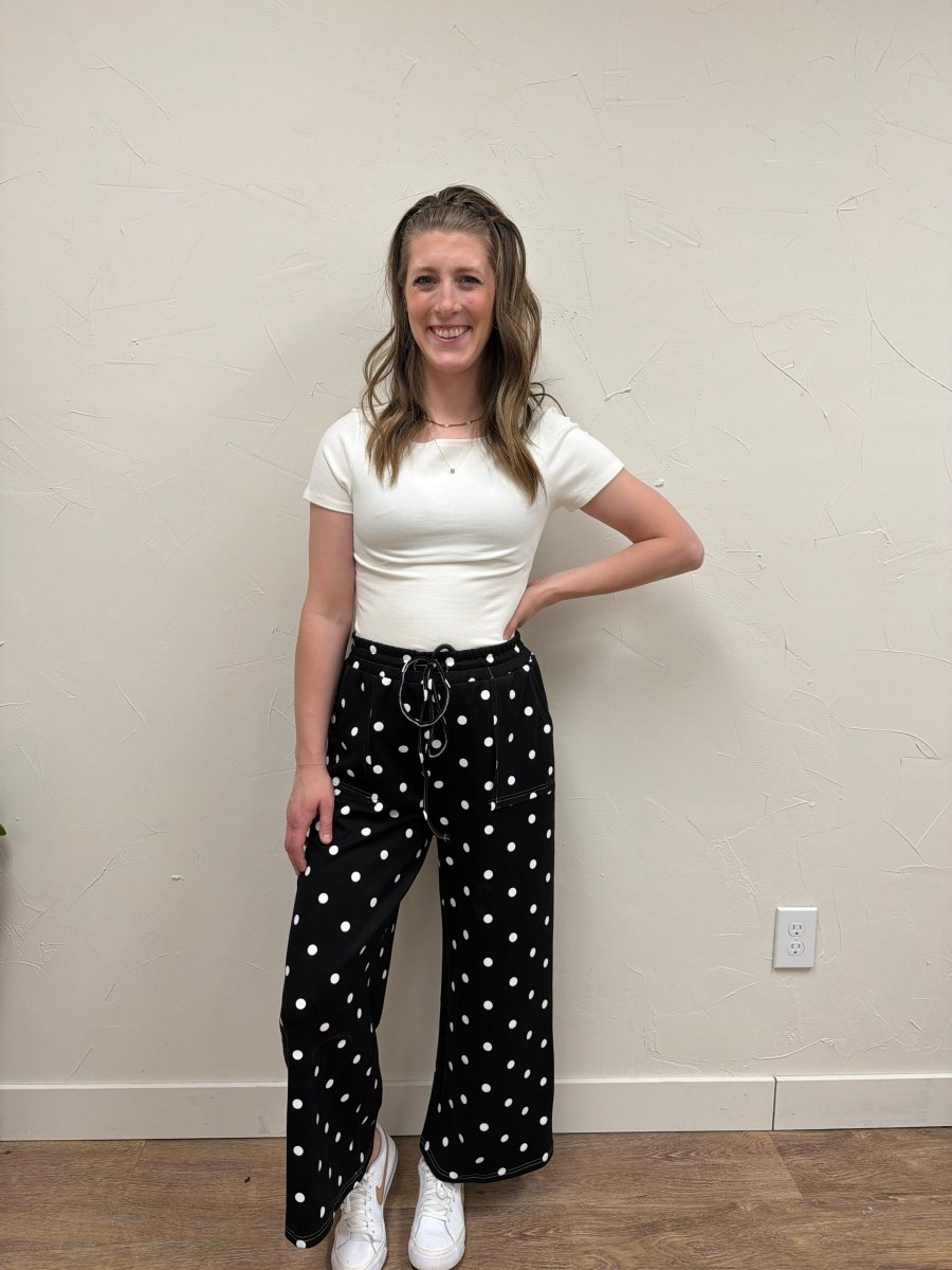 Front view of model wearing The Breanna Top with fitted silhouette and boat neckline — Three:Twelve Boutique