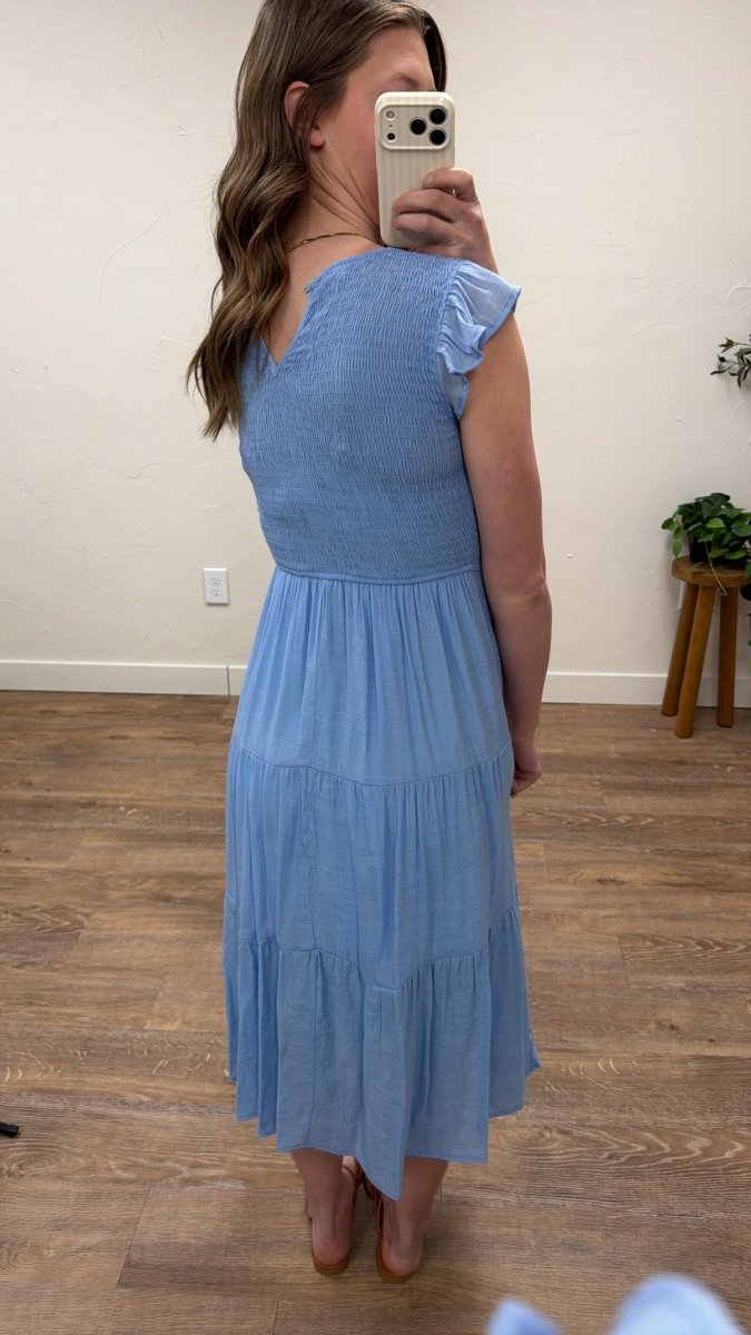 Back view of model wearing tiered midi dress showing smocked bodice — Three:Twelve Boutique