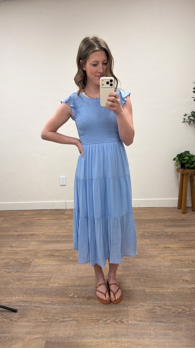 Front view of model wearing tiered smocked midi dress with short sleeves — Three:Twelve Boutique