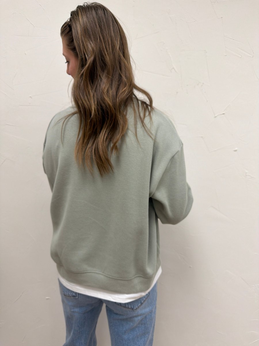 Back view of Twofer sweatshirt showing layered hem detail — Three:Twelve Boutique
