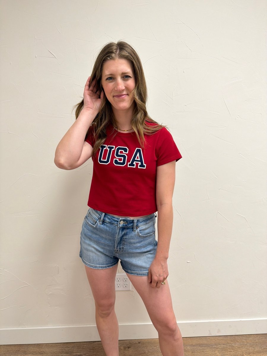Lifestyle image of model styling USA Short Sleeve Baby Tee — Three Boutique