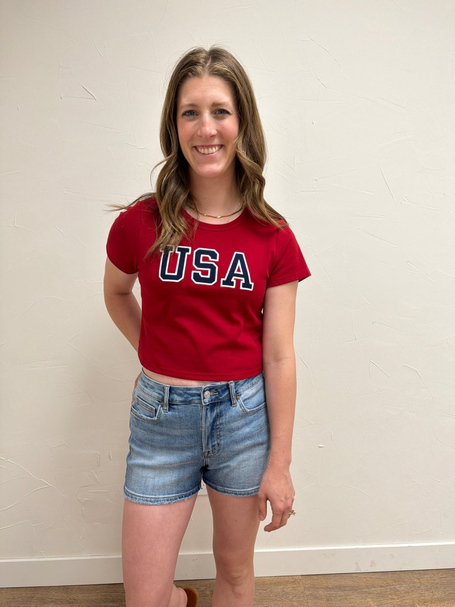 Lifestyle image of model styling USA Short Sleeve Baby Tee — Three Boutique
