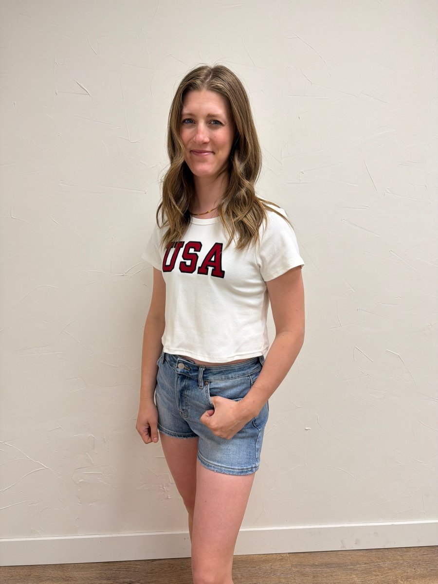Lifestyle image of model styling USA Short Sleeve Baby Tee — Three Boutique