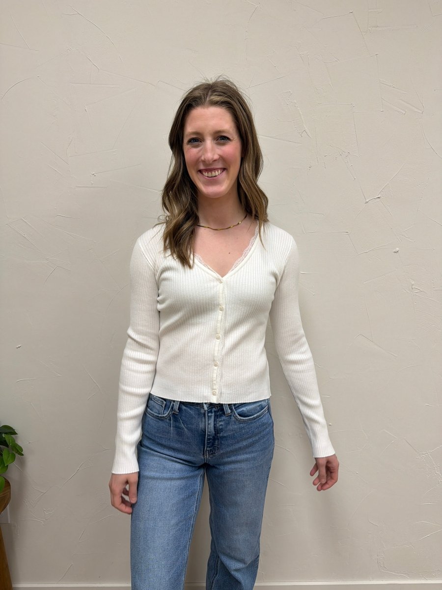 Lifestyle shot of model wearing V-Neck ribbed cardigan paired with denim and boots — Three:Twelve Boutique
