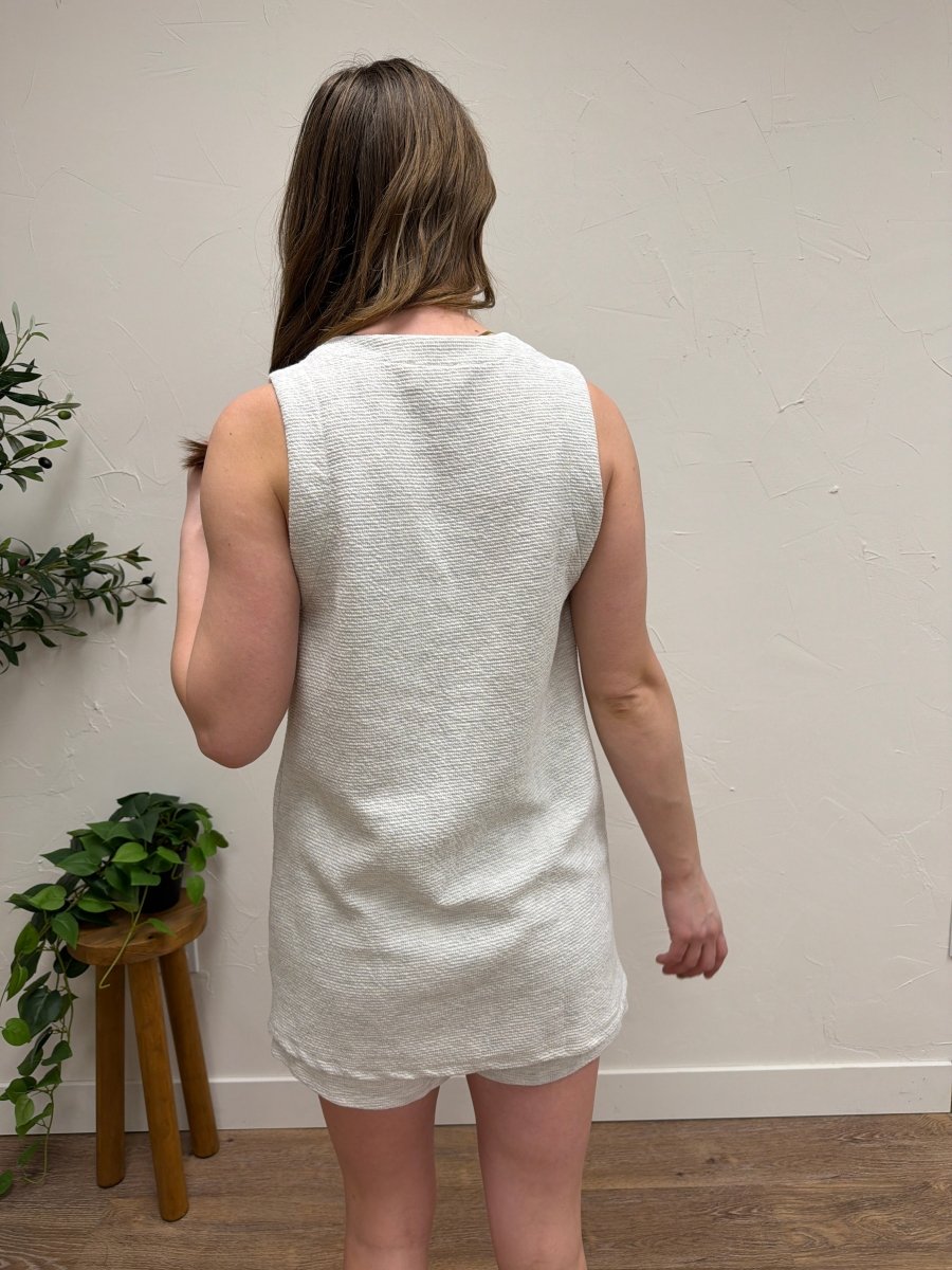 Back view of model wearing sleeveless tunic top highlighting clean silhouette — Three:Twelve Boutique