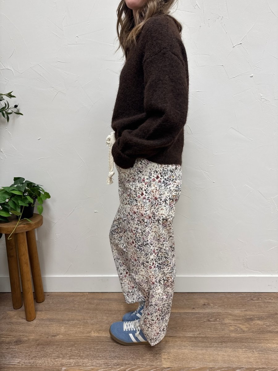 Side view of Wild Flowers printed pants highlighting relaxed barrel fit — Three:Twelve Boutique