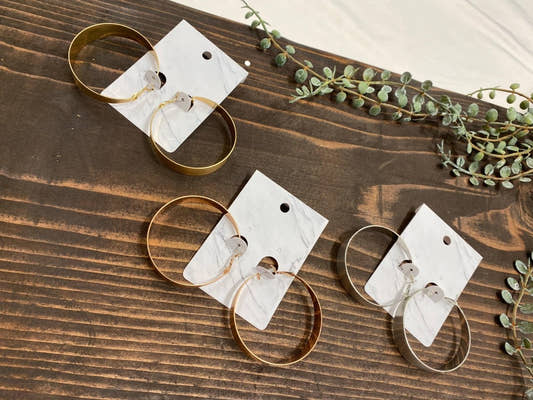 Front view of statement metal hoop earrings showing bold circular design — Three:Twelve Boutique